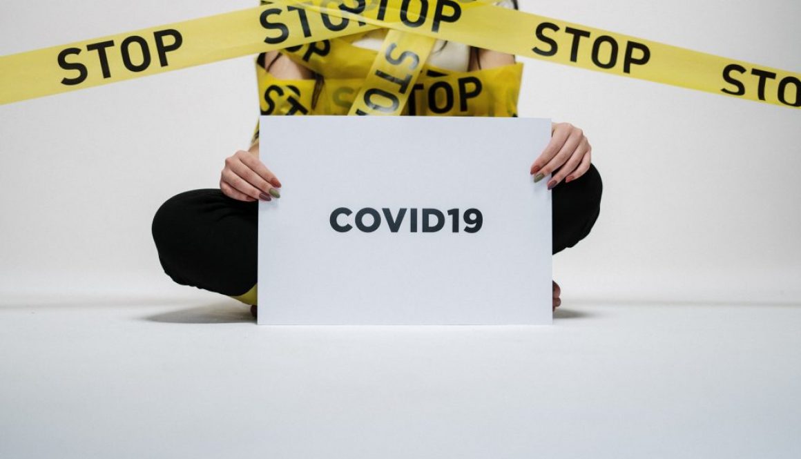 person-holding-covid-sign-3951600