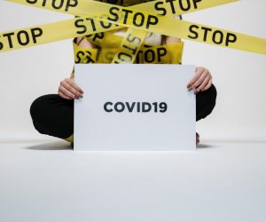 person-holding-covid-sign-3951600